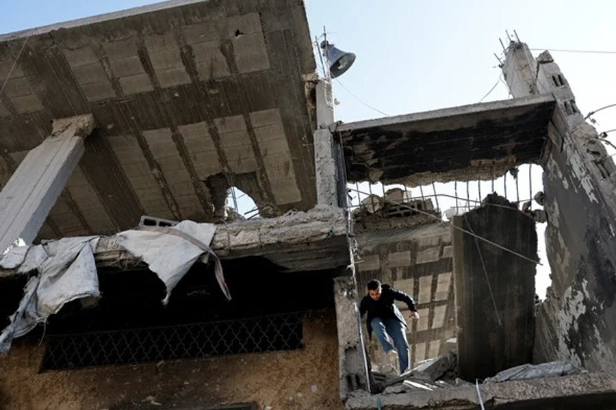 A man walks amid the wreckage after an Israeli air strike in the Balata refugee camp, Nablus, in the Israeli-occupied West Bank, Nov 18, 2023.