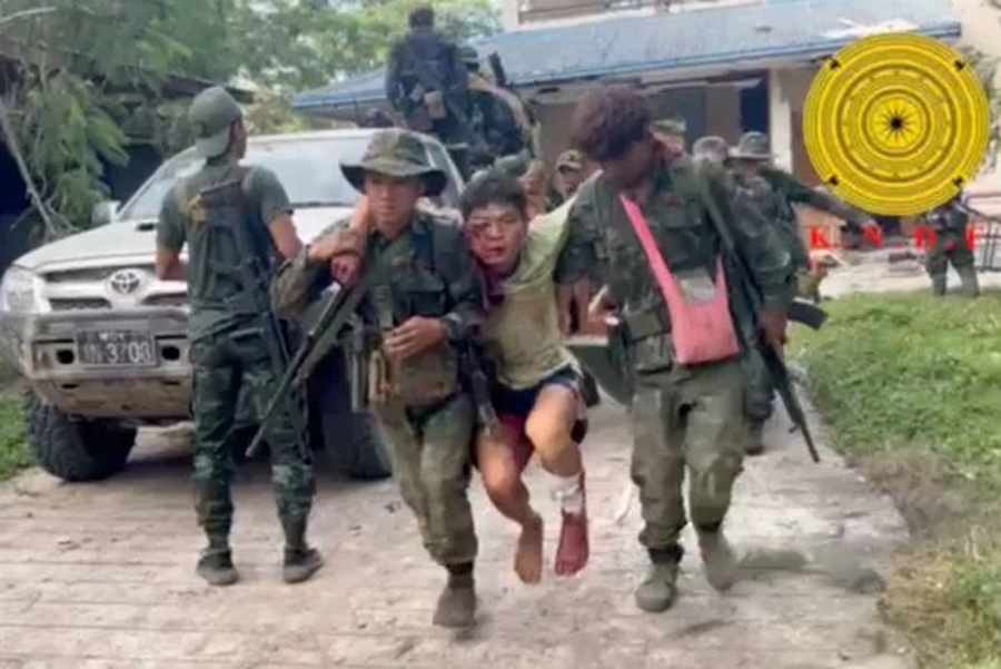 A wounded Myanmar military soldier who has surrendered to the Karenni Nationalities Defense Force is carried in Loikaw, Myanmar, in this still image taken from video released Nov 15, 2023.