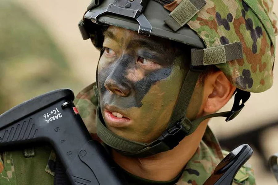 A Japanese Ground Self-Defense Force's Amphibious Rapid Deployment Brigade (ARDB) soldier takes part in a marine landing drill as a part of the country's nationwide 05JX military exercises at Tokunoshima island, Kagoshima prefecture, southwestern Japan, November 19, 2023.