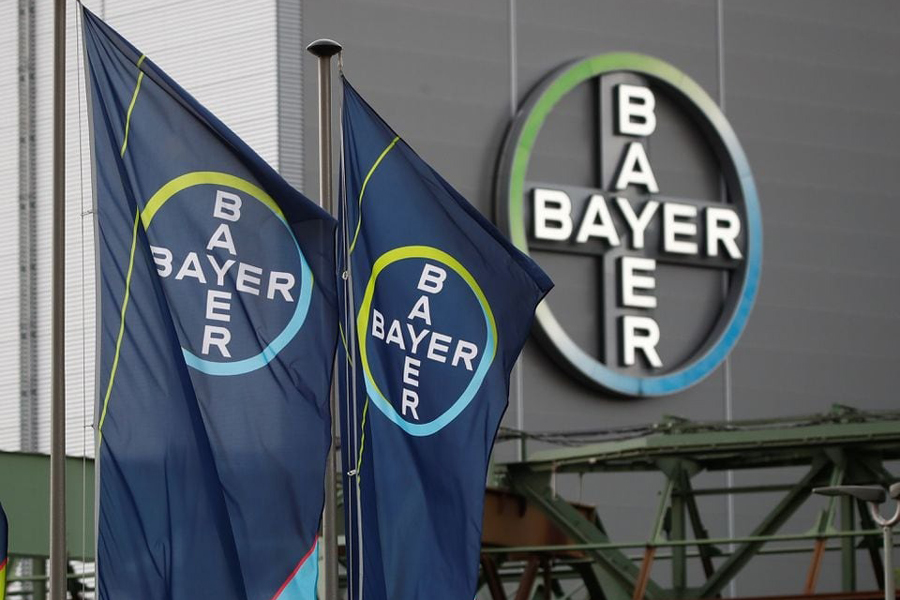 Logo and flags of Bayer AG are pictured outside a plant of the German pharmaceutical and chemical maker in Wuppertal, Germany August 9, 2019.
