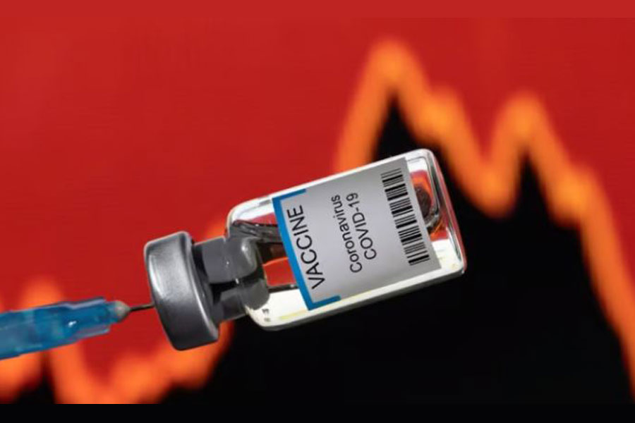 A vial labelled "VACCINE Coronavirus COVID-19" is seen in front of a stock graph in this illustration taken on Jan 17, 2022. REUTERS