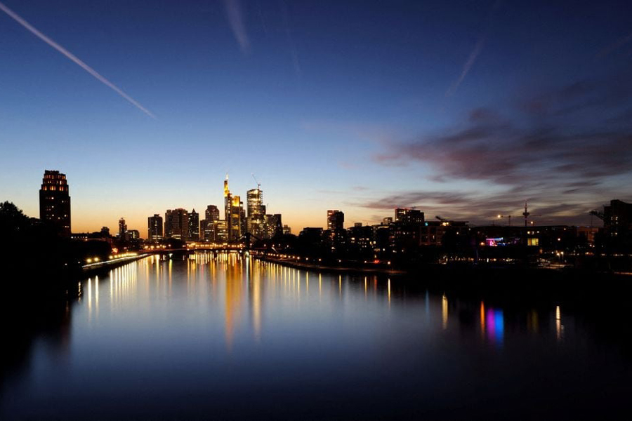The sun sets behind the skyline in Frankfurt, Germany, October 1, 2023.