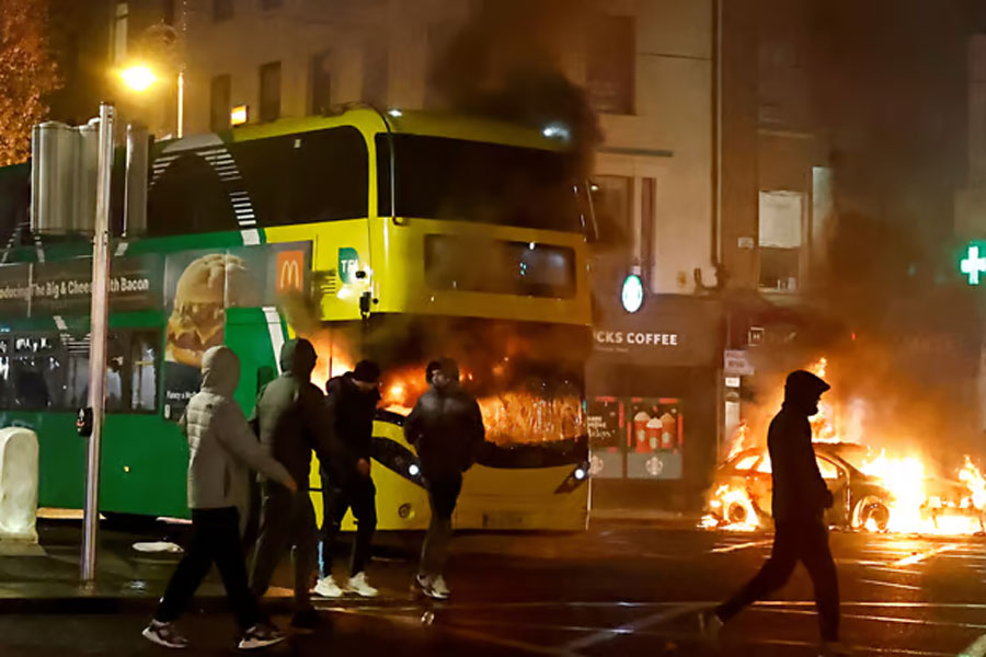 A bus burns during a demonstration following a suspected stabbing that left few children injured in Dublin, Ireland, November 23, 2023. REUTERS