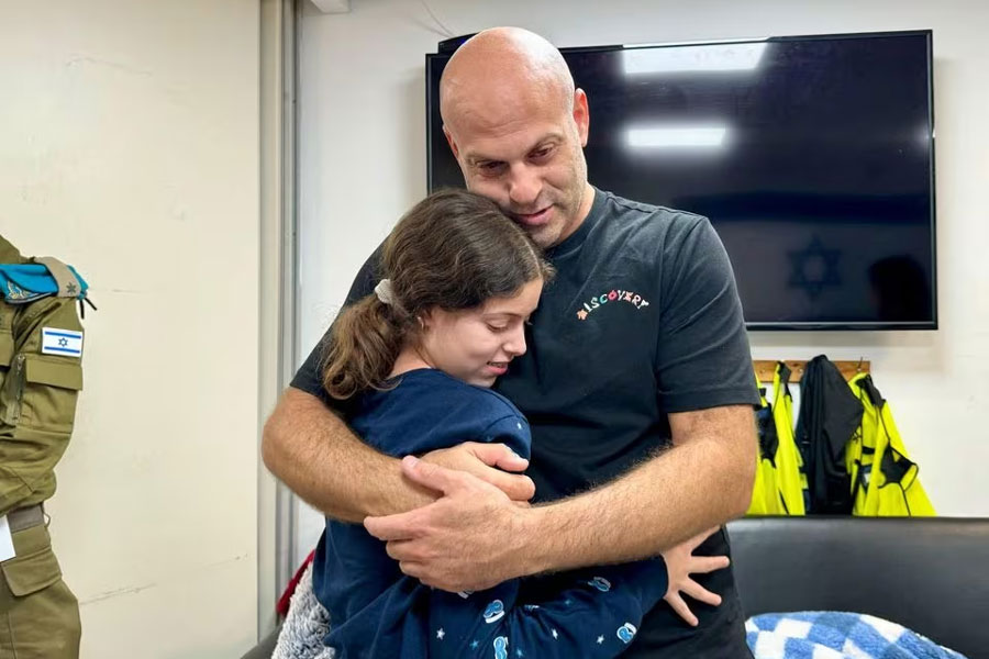 Hila Rotem-Shoshani, who was abducted by Hamas gunmen during the October 7 attack on Israel, meets a family member after being released as part of a hostages-prisoners swap deal between Hamas and Israel amid a temporary truce, at an unknown location in Israel, in this handout image released November 26, 2023. Israel Defense Forces/Handout via REUTERS Acquire Licensing Rights