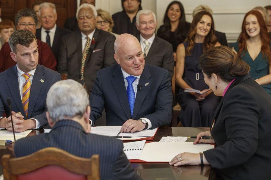 New Zealand Prime Minister Christopher Luxon, center, talks with with Governor-General Dame Cindy Kiro during the swearing-in ceremony at Government House in Wellington, New Zealand, Monday, Nov. 27, 2023. Luxon, the 53-year-old former businessman, was officially sworn in as New Zealand’s 42nd prime minister on Monday, and said his top priority was to improve the economy. (Mark Mitchell/New Zealand Herald via AP)