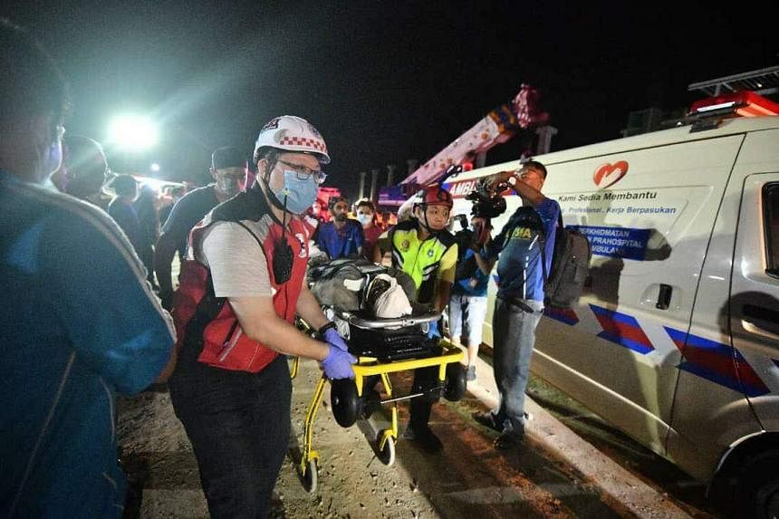 Rescue workers rushing one of the injured victims to an ambulance for medical attention. PHOTO: THE STAR/ASIA NEWS NETWORK