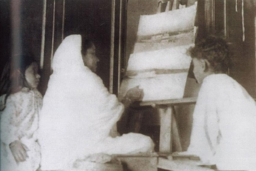 Nawabzadi Meherbanu Khanam is painting on a canvas with her children