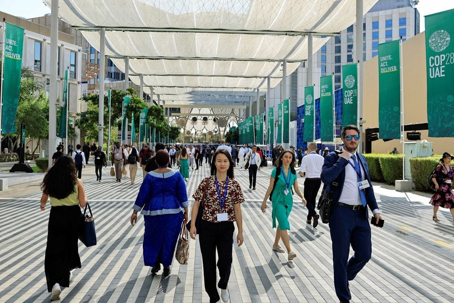 Delegates walk at the Dubai's Expo City during the United Nations Climate Change Conference (COP28) in Dubai, United Arab Emirates, December 4, 2023.