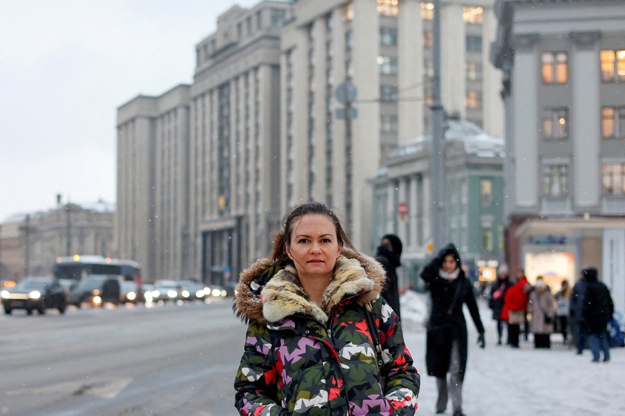 Maria Andreeva, whose husband was mobilised in October 2022 to join the Russian armed forces involved in a military campaign in Ukraine, poses for a picture in front of the headquarters of State Duma, the lower house of parliament, in central Moscow, Russia, November 30, 2023.