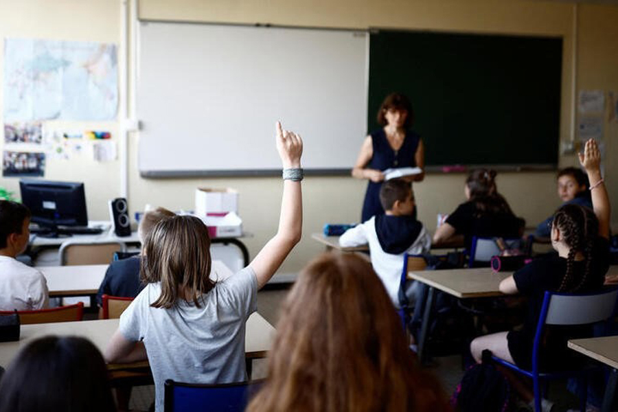 Schoolchildren work in a classroom on the first day of the new school year after summer break in Savenay, France, September 4, 2023.