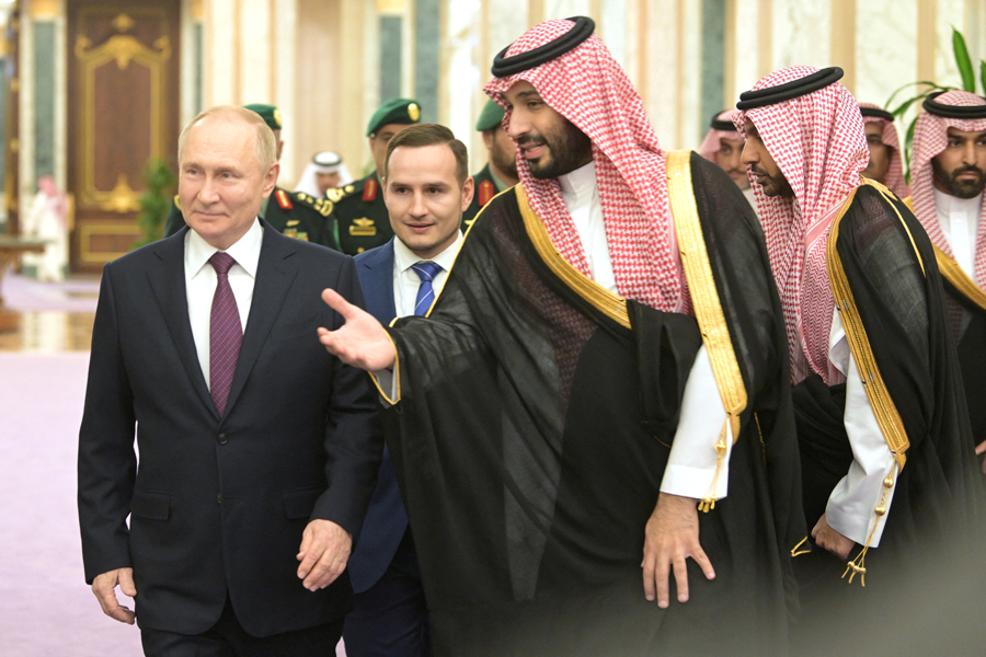 Russian President Vladimir Putin and Saudi Crown Prince Mohammed bin Salman walk during a meeting in Riyadh, Saudi Arabia December 6, 2023.