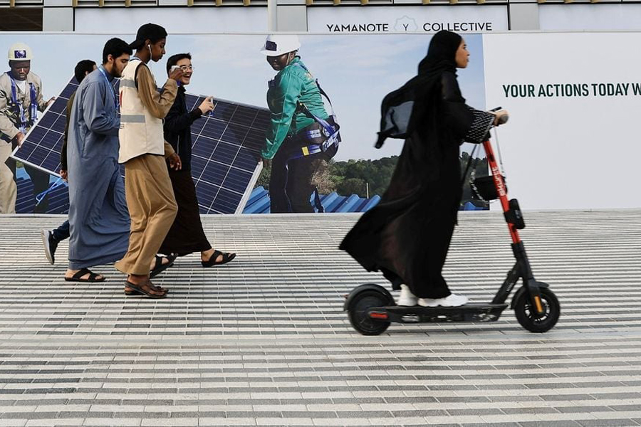 People walk in the Green zone at the United Nations Climate Change Conference (COP28) in Dubai, United Arab Emirates, December 8, 2023.