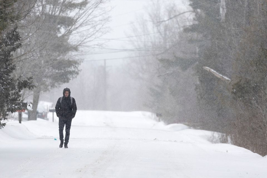 An asylum seeker walks down Roxham Road to cross into Canada from the US in Champlain, New York, US, February 28, 2023.