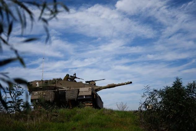 An Israeli soldier sits atop of a tank, amid the ongoing conflict between Israel and the Palestinian Islamist group Hamas, near the Israeli-Gaza Border, as seen from Israel, December 8, 2023. REUTERS/Amir Cohen