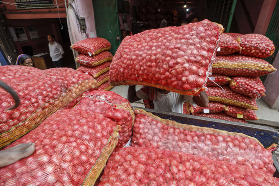 A labour loading bags of onion into a truck in Dhaka—Collected Photo