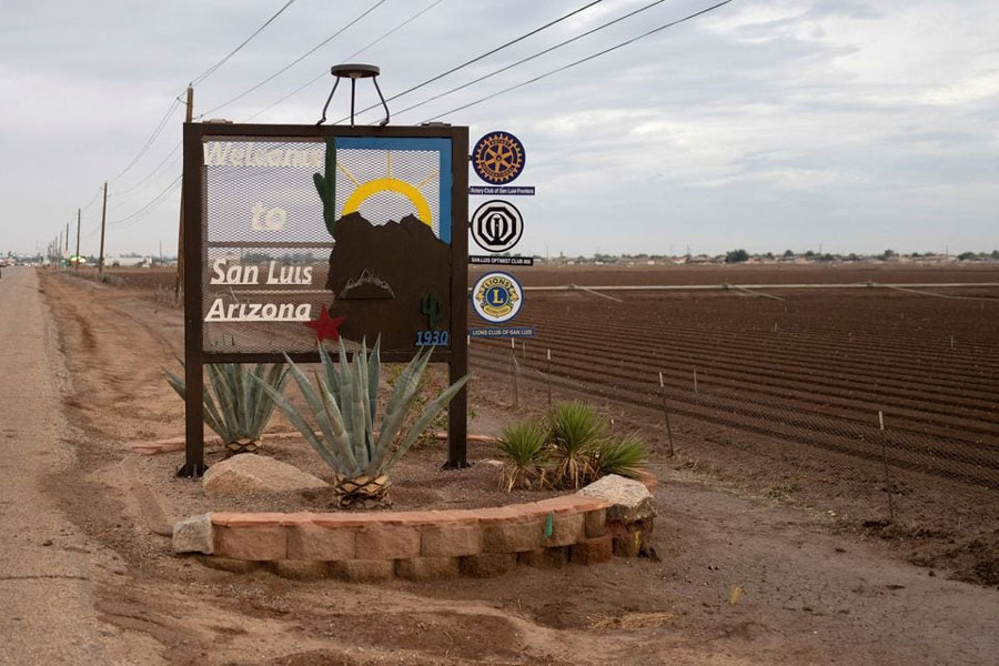 A welcome sign to San Luis is seen next to freshly planted farm fields, in the heavily Hispanic Yuma County, a Democratic stronghold in the southwestern corner of Arizona along the Mexico border, in San Luis, Arizona, US, November 16, 2023.