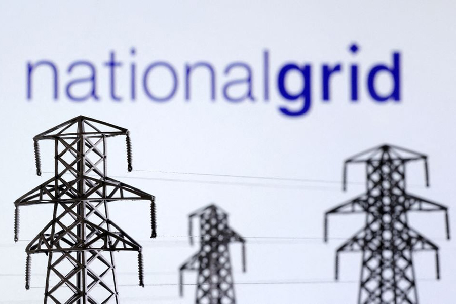 Electric power transmission pylon miniatures and National Grid logo are seen in this illustration taken, December 9, 2022.