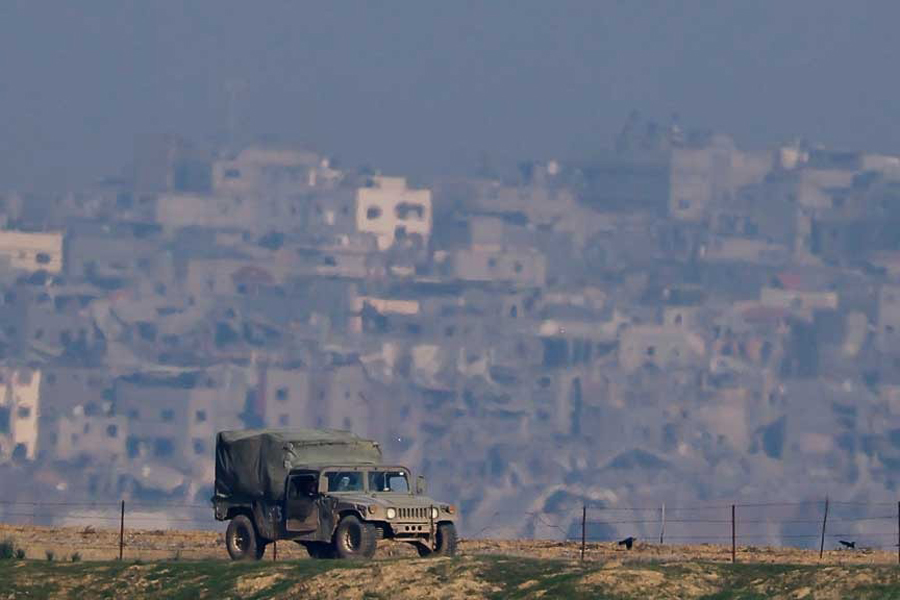 An Israeli military vehicle operates, amid the ongoing conflict between Israel and the Palestinian Islamist group Hamas, as seen from Southern Israel, Dec 18, 2023.