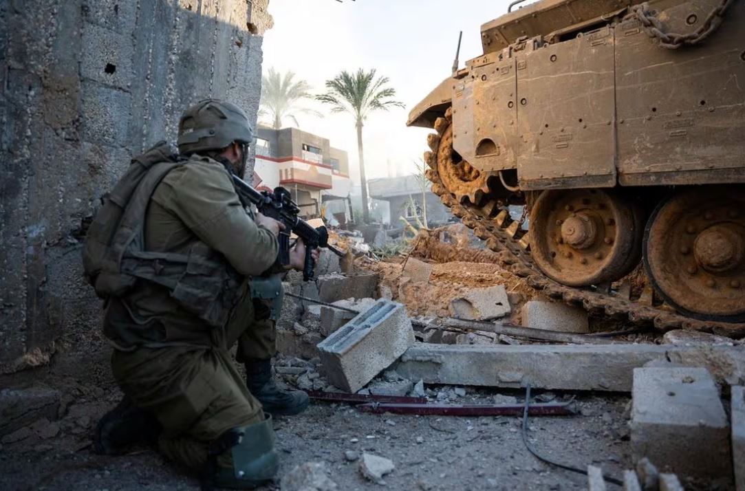An Israeli soldier operates in the Gaza Strip, amid the ongoing conflict between Israel and the Palestinian Islamist group Hamas, in this handout picture released on December 20, 2023. Israel Defense Forces/Handout via REUTERS