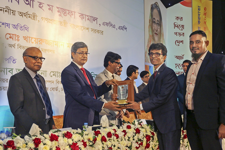 Walton Plaza's Managing Director Mohammad Rayhan is receiving national tax card and best taxpayer award.