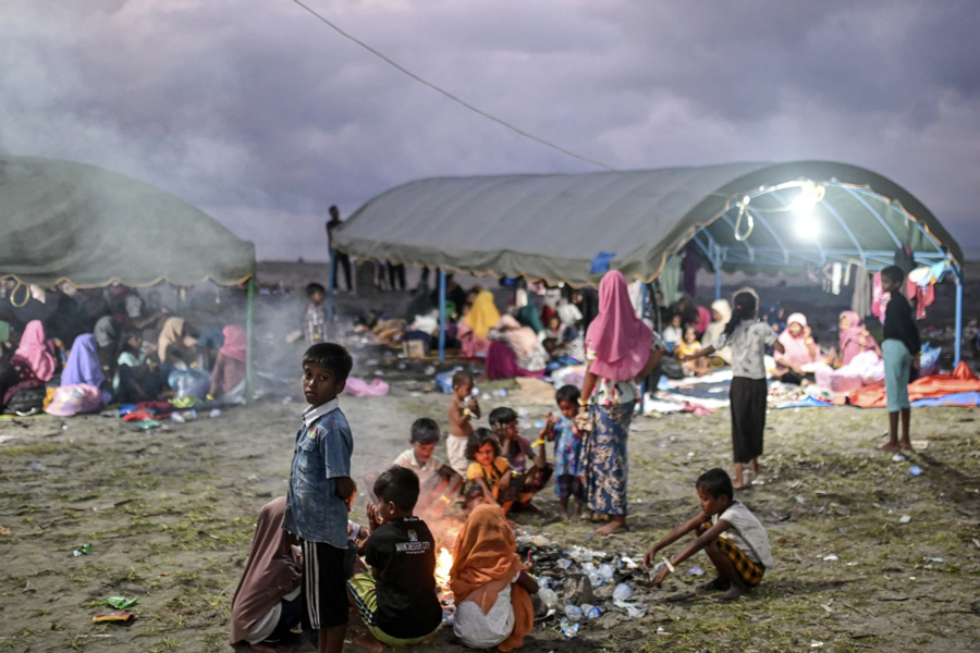 Ethnic Rohingya women take shelter under a tent near a beach where they landed on Dec 10 in Pidie, Aceh province, Indonesia, Saturday, Dec 16, 2023.