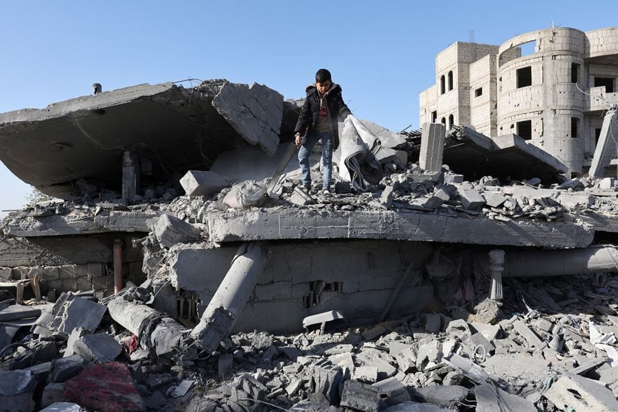 A Palestinian stands at the site of an Israeli strike on a house, amid the ongoing conflict between Israel and the Palestinian Islamist group Hamas, in Rafah, in the southern Gaza Strip December 22, 2023.