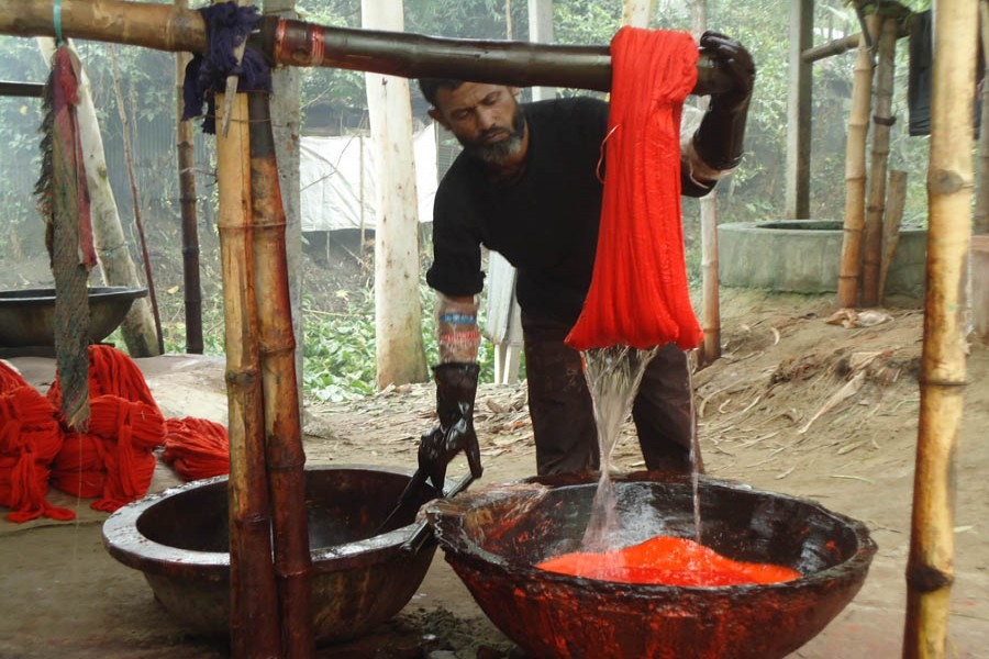A worker busy dying fabric on the premises of a weaving factory in Belkuchi upazila of Sirajganj district —FE Photo
