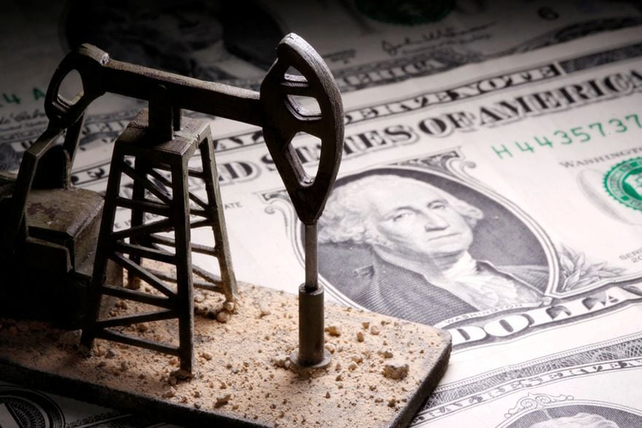 A 3D printed oil pump jack is placed on dollar banknotes in this illustration picture, April 14, 2020.