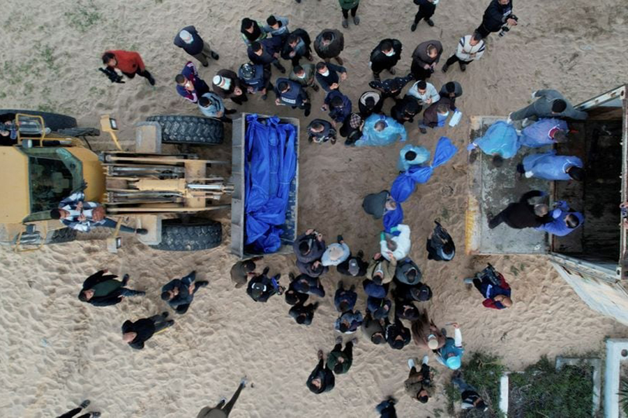 People prepare to bury Palestinians, who were killed by Israeli strikes and fire, after their bodies were released by Israel, amid the ongoing conflict between Israel and the Palestinian Islamist group Hamas, at a mass grave in Rafah, in the southern Gaza Strip on December 26, 2023 — Reuters photo