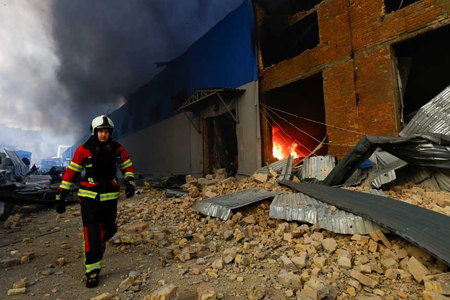 A firefighter works at a site of a warehouse heavily damaged during a Russian missile strike, amid Russia's attack on Ukraine, in Kyiv, Ukraine Dec 29, 2023.