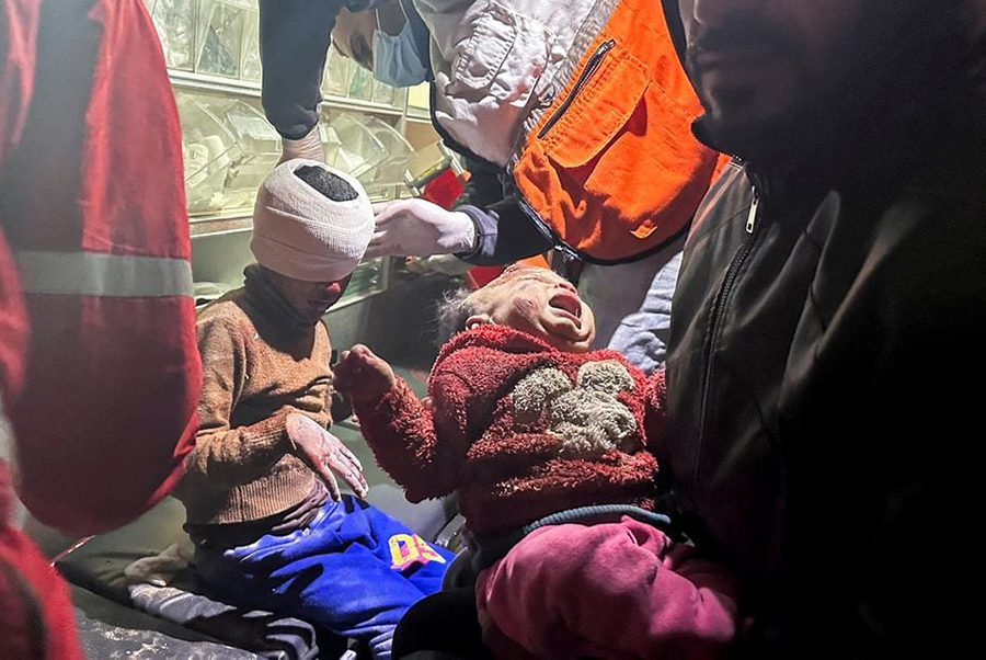 Palestinian girl Mariam Abu Akel and her brother Hamed, who were rescued from under the rubble of a house hit by an Israeli strike, amid the ongoing conflict between Israel and the Palestinian Islamist group Hamas, receive medical attention inside an ambulance, in Rafah in the southern Gaza Strip on December 29, 2023