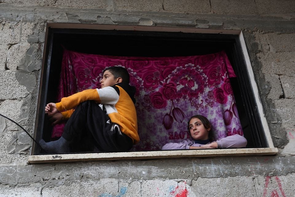 Palestinian children look on from a window in Khan Younis, southern Gaza Strip, Palestine on December 13, 2023