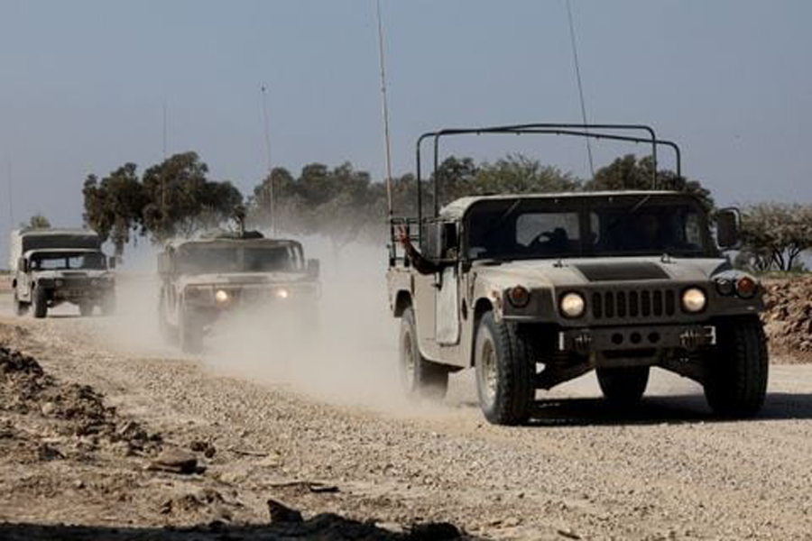 Israeli military vehicles move near the Israel-Gaza border, amid the ongoing conflict between Israel and the Palestinian Islamist group Hamas, in southern Israel, December 31, 2023.