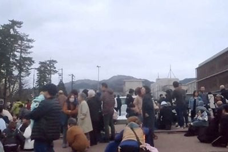 People evacuate to higher ground at a parking space of a junior high school after a tsunami warning issued caused by an earthquake in Wajima, Ishikawa prefecture, Japan January 1, 2024, in this still image from a video released by Kyodo.