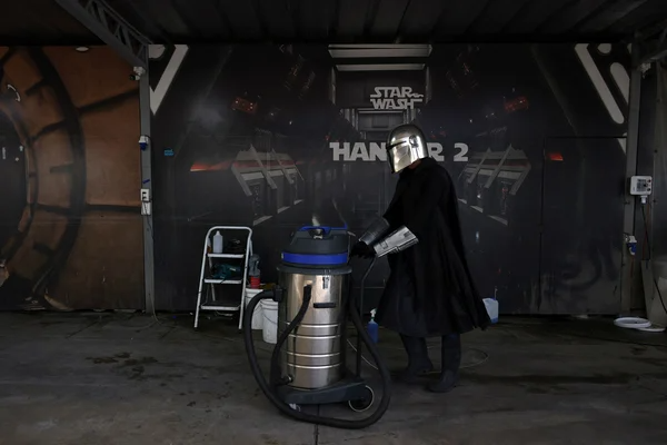 A worker dressed as a 'Star Wars' character pushes a vacuum cleaner at a themed car wash service called 'Star Wash', which is a play on the words 'Star Wars, in Santiago, Chile, December 26, 2023. |REUTERS