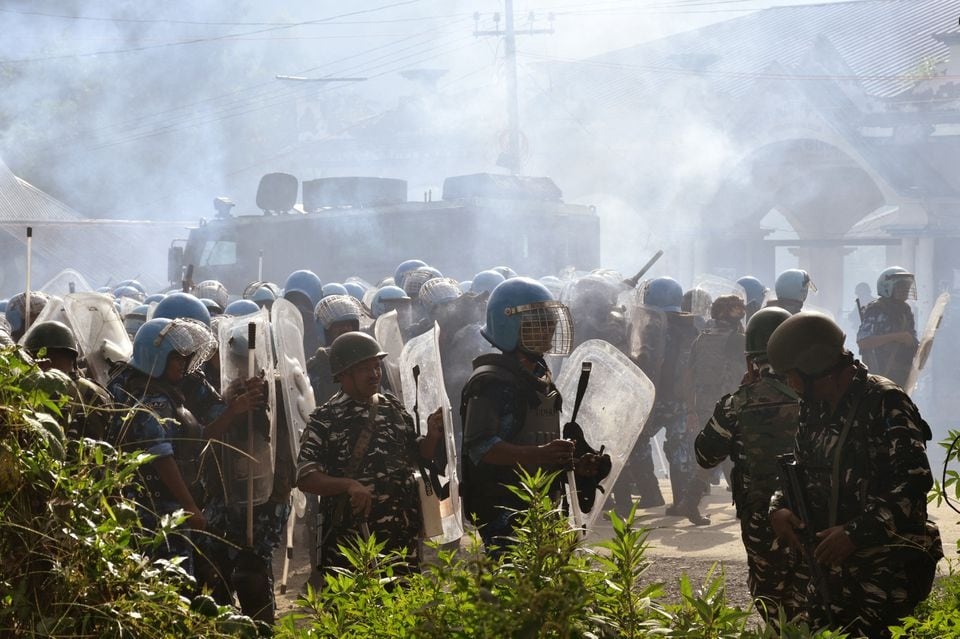 Police officers stand amidst smoke billowing out from tear gas shells fired to disperse the crowd gathered to demand the removal of the army barricades in Bishnupur district, in the northeastern state of Manipur, India on September 6, 2023 — Representational photo via Reuters/Files