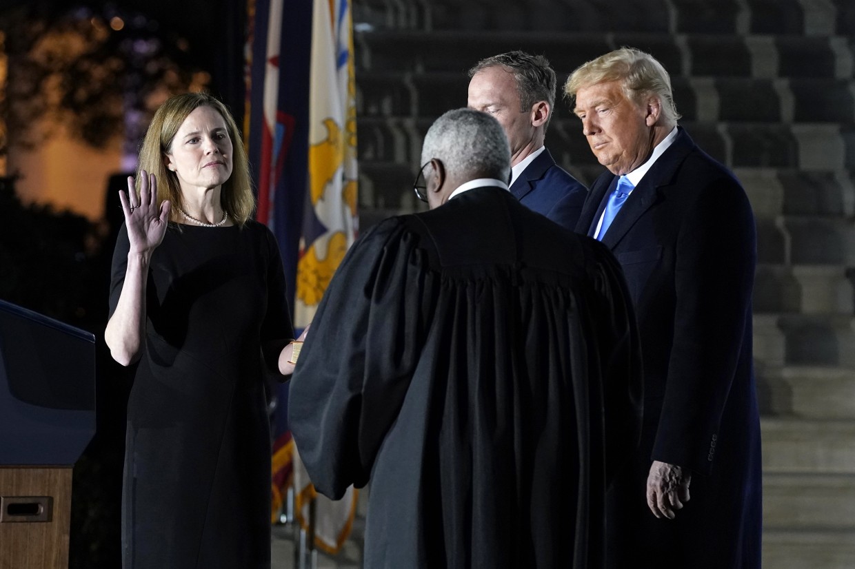 Then-President Donald Trump watches as Justice Clarence Thomas swears in Amy Coney Barrett on Oct. 26, 2020.Patrick Semansky / AP