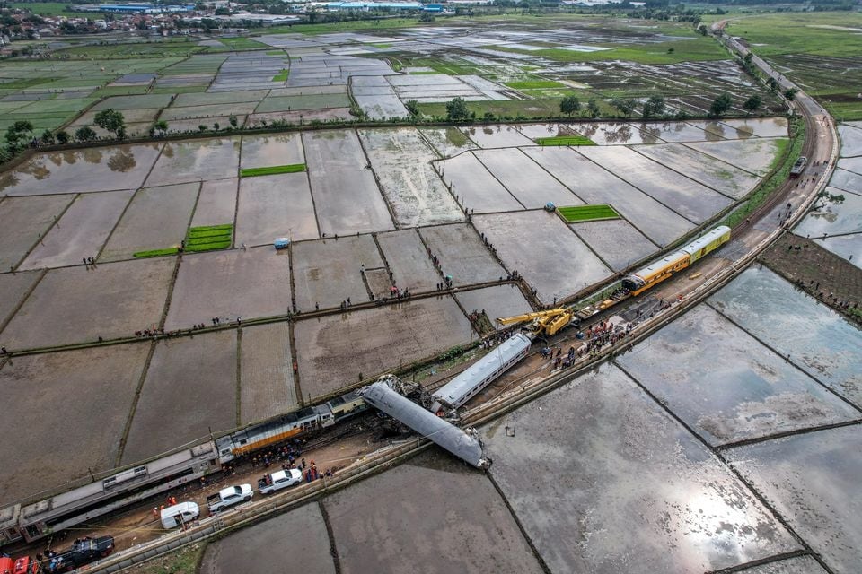 An aerial view shows a crane operating to clear the wreckage after a train collision between the local Bandung Raya train and the Turangga train in Cicalengka, Bandung, West Java province, Indonesia on January 5, 2024 — Antara Foto via REUTERS