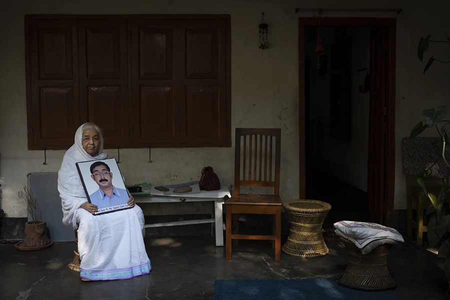 Hazera Khatun, 70, holds a portrait of her son Sajedul Islam Sumon, a local BNP politician who has been missing for over 10 years, in Dhaka, Bangladesh, on January 4, 2024. Khatun founded Mayer Daak, or Mother's Call, a platform for family members of victims of enforced disappearances in Bangladesh after the disappearance of her son — AP photo