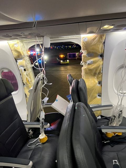 Passenger oxygen masks hang from the roof next to a missing window and a portion of a side wall of an Alaska Airlines Flight 1282, which had been bound for Ontario, California and suffered depressurization soon after departing, in Portland, Oregon, US, January 5, 2024 in this picture obtained from social media
