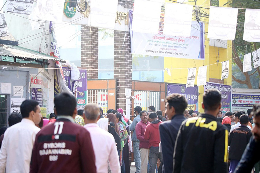 Voters queuing up in front of a polling centre for casting their vote in the 12th national election on Sunday.