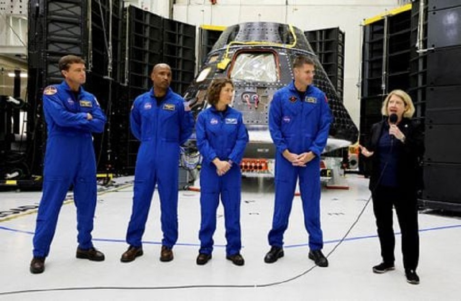 Astronauts for NASA's Artemis II mission stand in front of their Orion crew capsule, expected to carry Reid Wiseman, commander, Victor Glover, pilot, and mission specialists Christina Hammock Koch and Jeremy Hansen, with the Canadian Space Agency, as NASA Deputy Administrator Pam Melroy speaks at a press conference at the Kennedy...