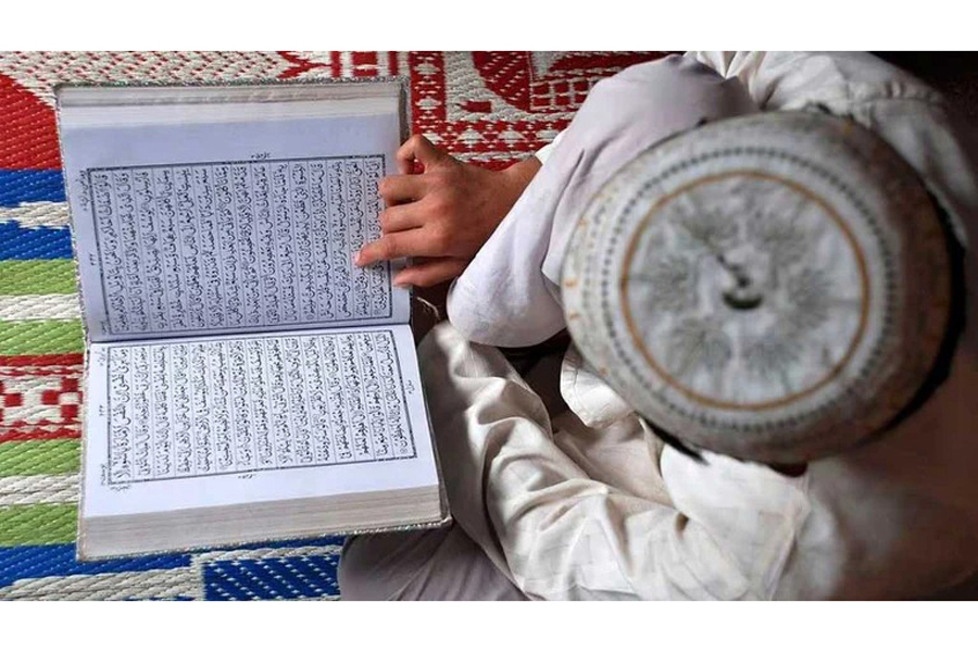 A Muslim boy reads the Koran at a madrasa or religious school on the first day of the holy month of Ramadan in the northern Indian city of Mathura Aug 23, 2009.
