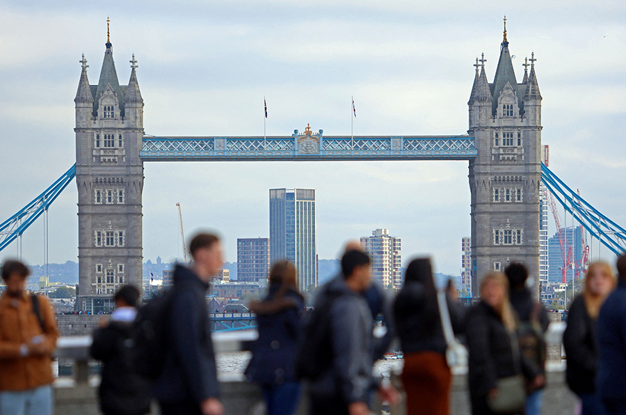 People walk over London Bridge looking at a view of Tower Bridge in the City of London financial district in London, Britain on October 25, 2023 — Reuters/Files