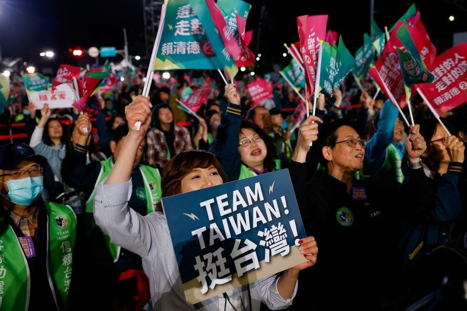 Supporters of the Democratic Progressive Party (DPP) gather near the DPP party headquarters, as they wait for preliminary results of the presidential and parliamentary elections, in Taipei, Taiwan on January 13, 2024 — Reuters