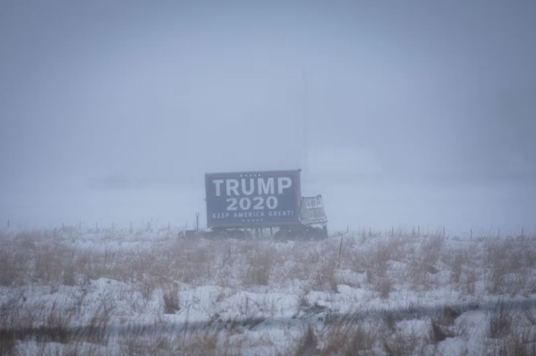 A campaign billboard of Republican presidential candidate and former U.S. President Donald Trump is seen ahead of the Iowa caucus vote, outside Colfax, Iowa, U.S., January 13, 2024. REUTERS/Marco Bello