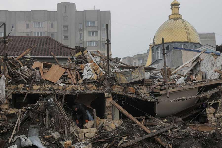 A local resident removing debris at the site where a residential building was destroyed during a Russian missile strike in Odesa of Ukraine on December 29 last year –Reuters file photo