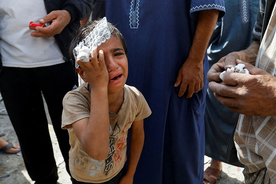 A Palestinian boy reacts at the site of Israeli strikes on houses, in Rafah in the southern Gaza Strip on October 17, 2023 — Reuters/Files