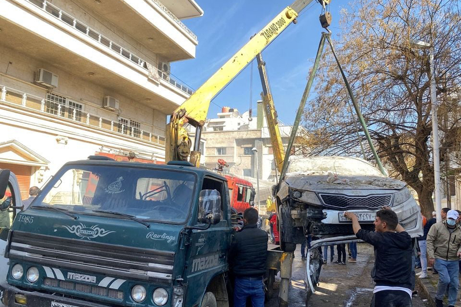 A crane lifts a damaged car near a site that was hit by an Israeli strike according to sources, in the Mazzeh neighbourhood of Damascus, Syria January 20, 2024.