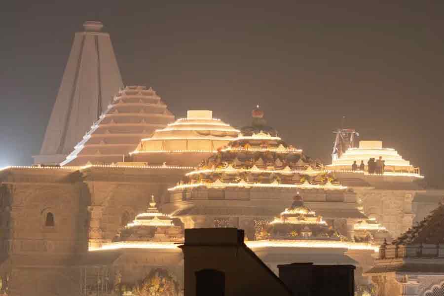 Labourers standing on top of the illuminated grand temple of Lord Ram ahead of its opening in Ayodhya in India recently –Reuters file photo